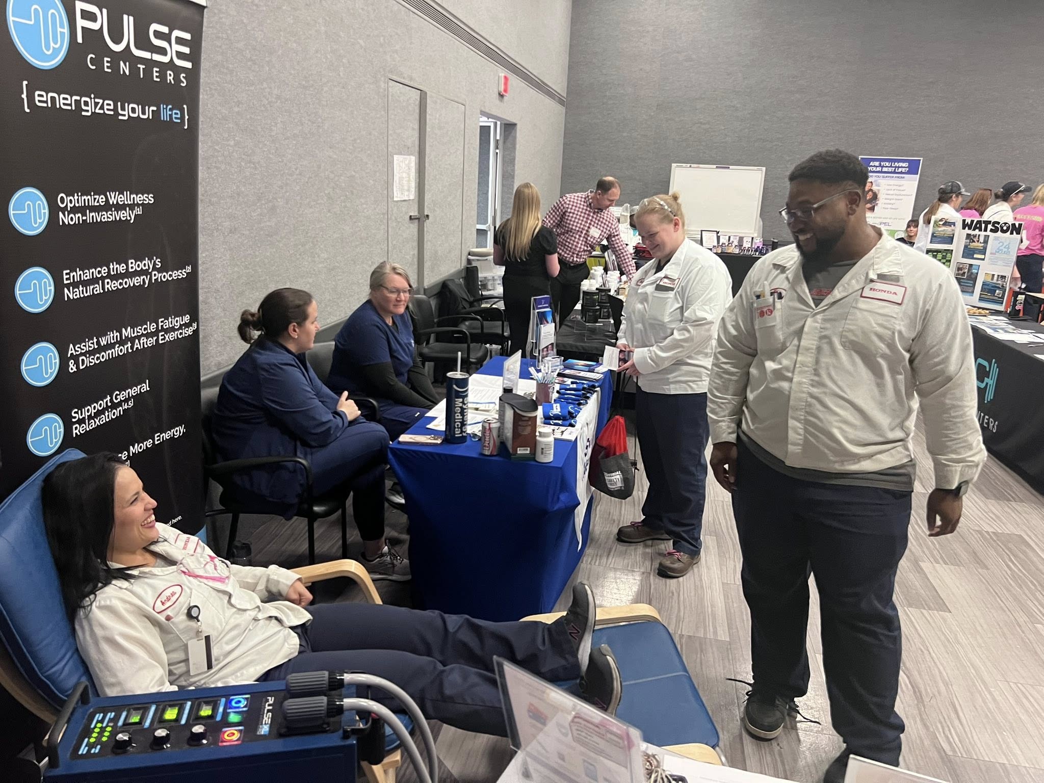 People gathered around a wellness demonstration booth