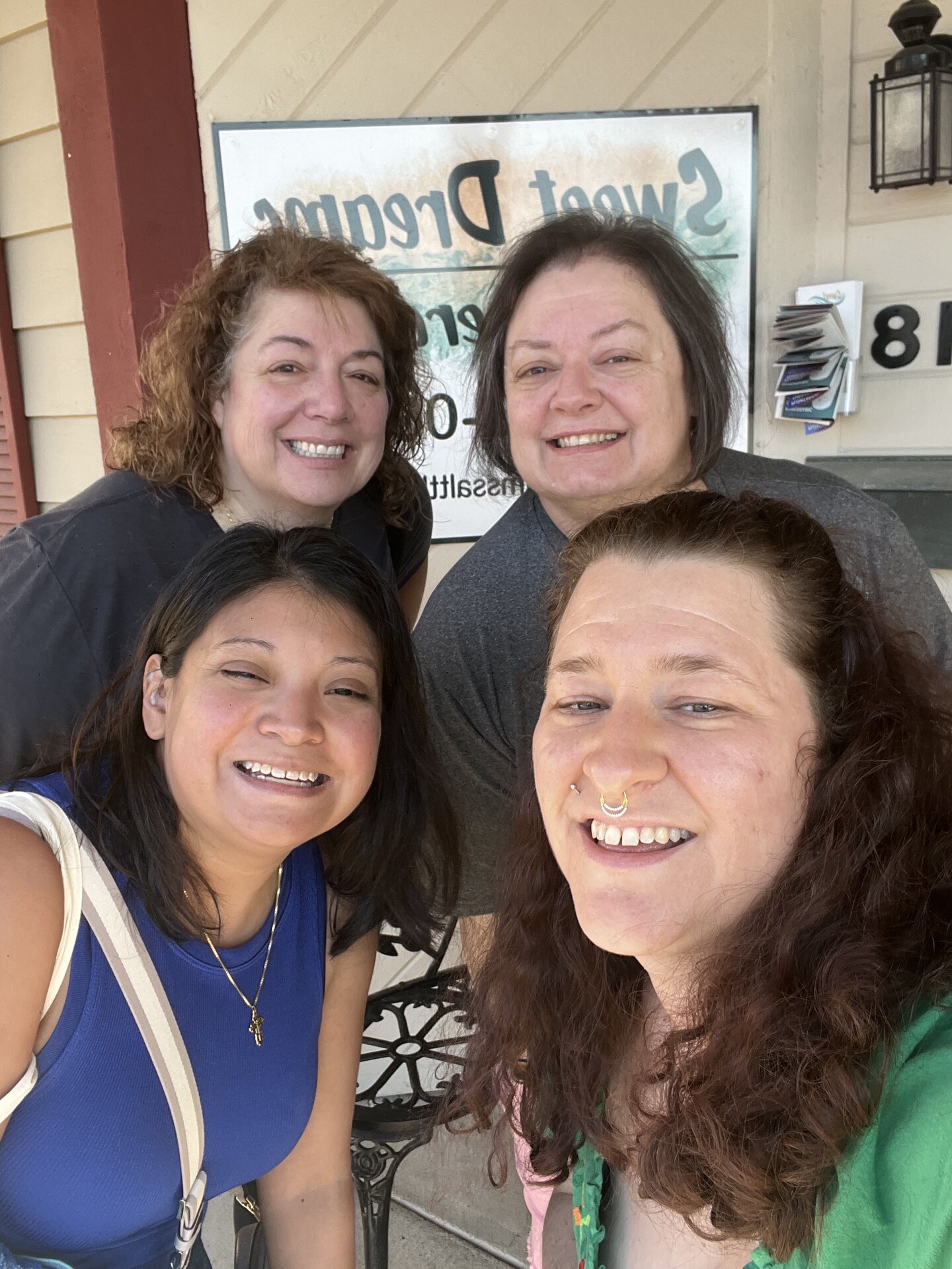 Four people smiling for a group photo