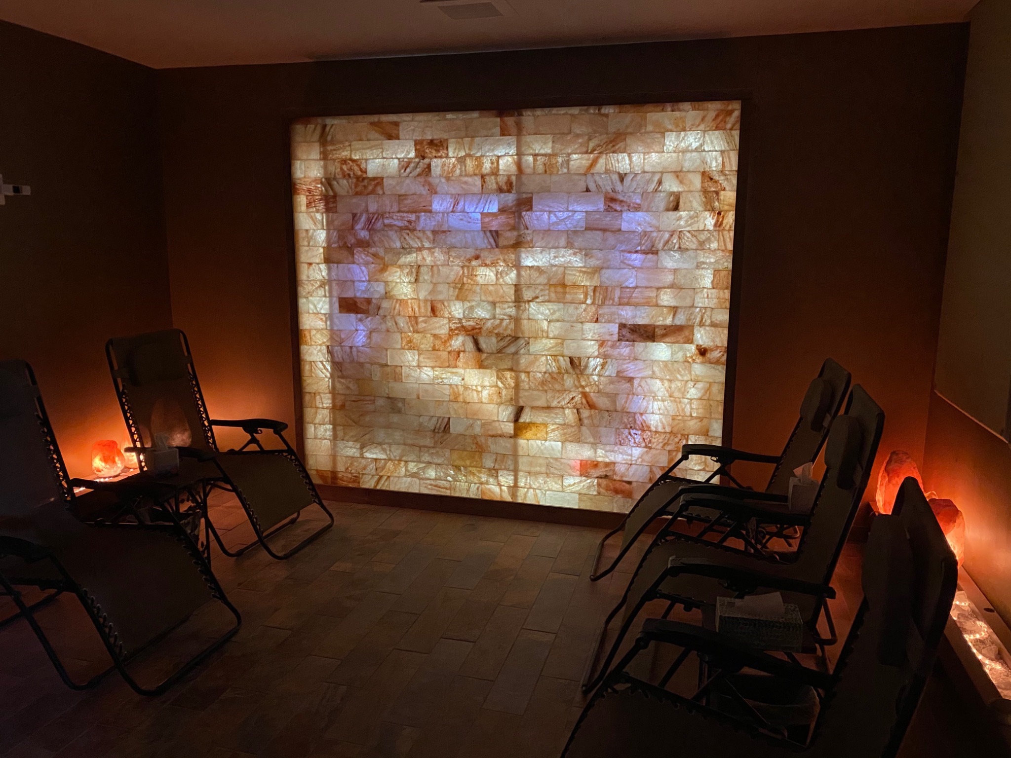 Reclining chairs facing the illuminated salt wall at Sweet Dreams in Plain City